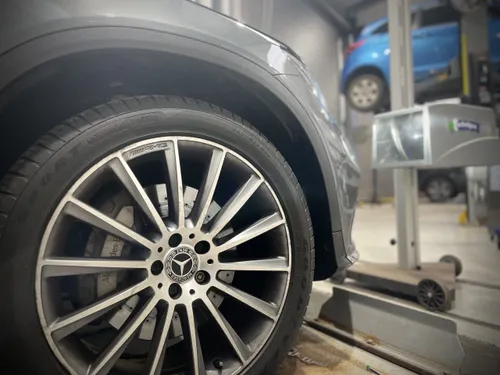 Mechanic inspecting vehicle during MOT